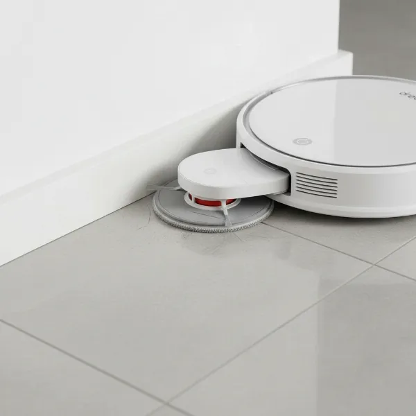 Dreame L20 Ultra robot vacuum extending its mop pads to clean along a wall edge.